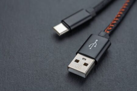 Type C USB cable with cable against a dark background..の写真素材