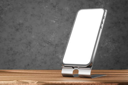 Smartphone mockup with white screen. A mockup of a smartphone on a stand on a wooden table and a dark background. 3d rendering.の写真素材