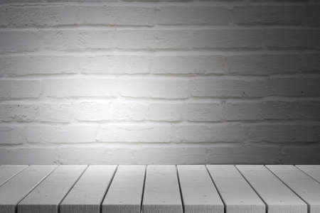 White wooden table against a white brick wall background. 3d render.