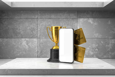 Smartphone with gold cups, coins and bank cards on a concrete background. Smartphone blank screen...