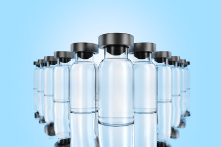 The medicine inside appears to be a clear, colored liquid. Medicine bottle mock up. It is a small, clear glass container with a narrow neck and a rubber stopper. 3d rendering.の写真素材