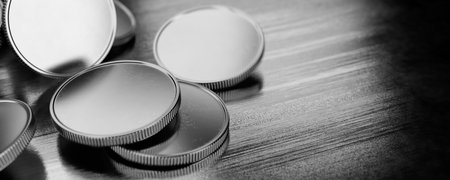 The concept of donations, savings. Silver coins without lying on a metal table. 3d rendering.