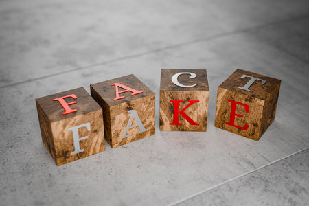 Cubes with the description fake and facts. Write fake or fact. Differences in truth. Truth or lie. Spreading disinformation in the state. Deceiving citizens, leading to war. 3D rendering.の写真素材