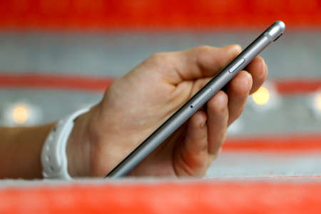 A close up of a hand holding a cellphone. High quality photo