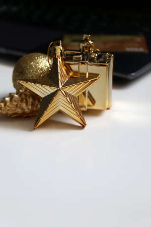 New Years shopping online. Christmas online shopping. Golden tree decoration on a blurred...