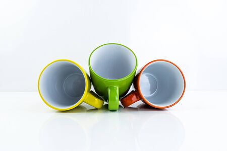 Colorful mugs on  background   . Ceramic coffee cup for montage or design.Isolate, horizontal view.の写真素材