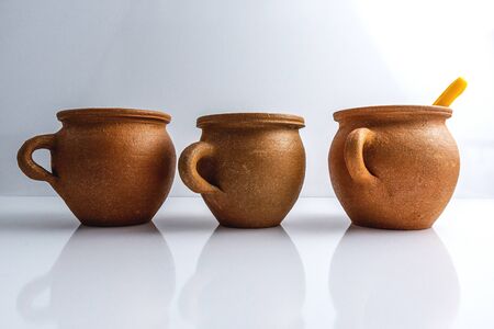 Clay pots for cooking isolated on white backgroundの写真素材