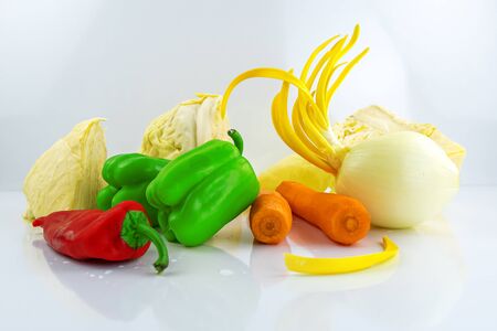 Fresh vegetables isolated on a white background.Onion,red and green pepper,cabbage,carrotの写真素材