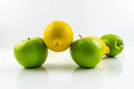 Green apples with lemons isolated on white backgroundの写真素材