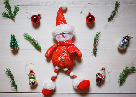 Christmas composition. snowman, tree branches and Christmas toys on wooden white background