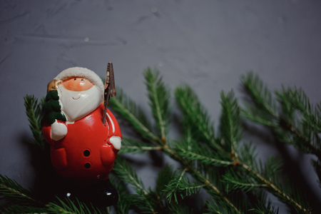 fir branch and toy Santa Claus on dark background, copy spaceの写真素材