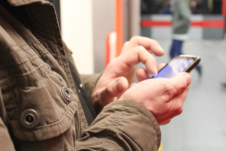 close up of male hands using a smartphoneの写真素材