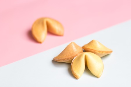 fortune cookie on pink and blue background, pastel colorsの写真素材