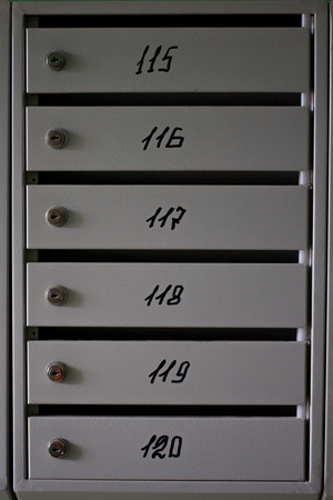 gray metal mailboxes in the entrance of a apartment building