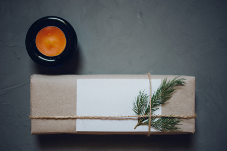 Christmas background with fir tree and decor, gift box, candle. Top view with copy space, gray plastered backgroundの写真素材