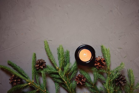 Close up Christmas background with fir tree and decor, candle, Top view with copy space, gray backgroundの写真素材