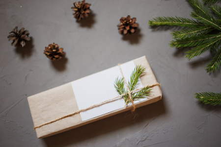 Christmas background with fir tree and decor, branches and cones. Top view with copy space, gray plastered backgroundの写真素材