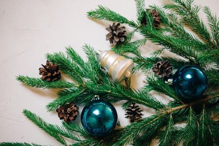 Christmas background with fir tree and decor, branches and cones. Top view with copy space, white backgroundの写真素材