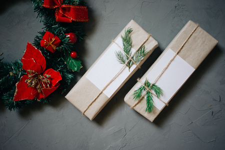 two gift boxes, decorated Christmas wreath and candles, copy space, top view, gray plastered backgroundの写真素材