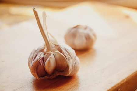 close up the garlic on a wooden cutting boardの写真素材