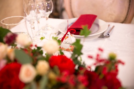 table decor for wedding ceremony, table setting, flowers, red and white decorの写真素材