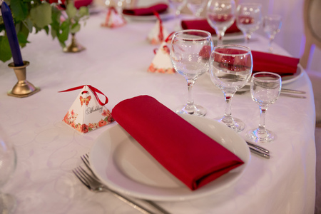 close up table decor for wedding ceremony, table setting, flowers, red and white decorの写真素材