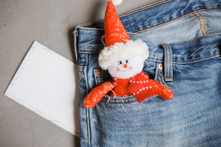 Moscow, Russia - 08 30 2018:Merry Christmas and a happy New Year card with snowman in the jeans pocketの写真素材