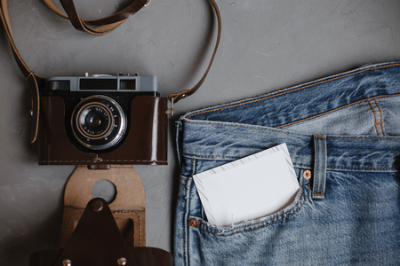 Moscow, Russia - 08 30 2018:top view blue jeans, vintage retro camera, card in pocket, copy spaceの写真素材