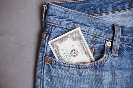 Moscow, Russia - 08 30 2018: Money financial concept. Two dollar banknote in a pocket of blue jeans...