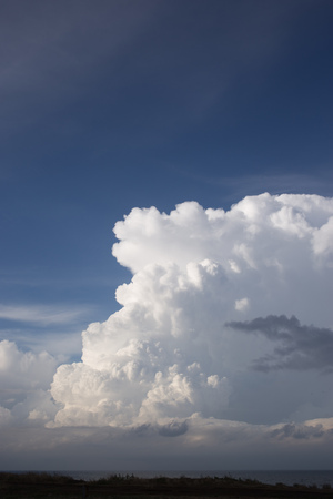 Cumulus clouds and sun in the skyの写真素材