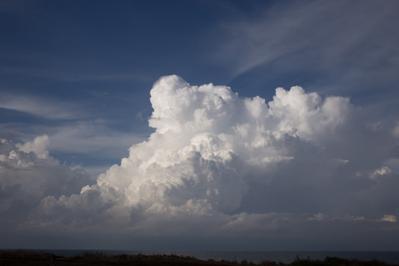 Cumulus clouds and sun in the skyの写真素材