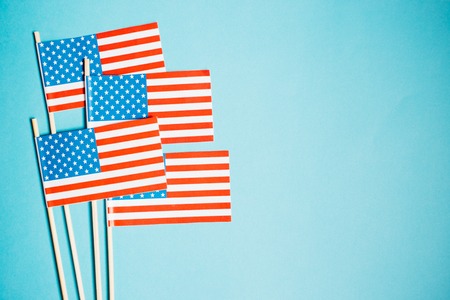 Miniature paper flag USA. American Flag on blue background.の写真素材
