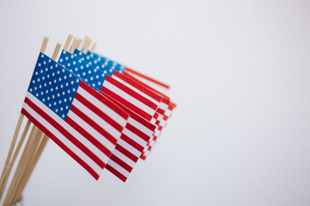 Miniature paper flags USA. American Flag on white background.の写真素材