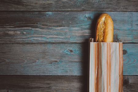 Fresh bread baguette on wooden table. Top view with space for your textの写真素材