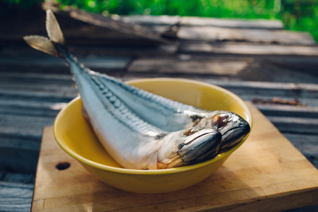 two fresh fish on a cutting Board, cooking mackerel,fish tails close upの写真素材