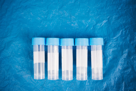 tube for sampling biological material on a blue background, top viewの写真素材
