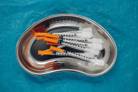 some syringes in a steel medical tray, medical items, taking biomaterialの写真素材