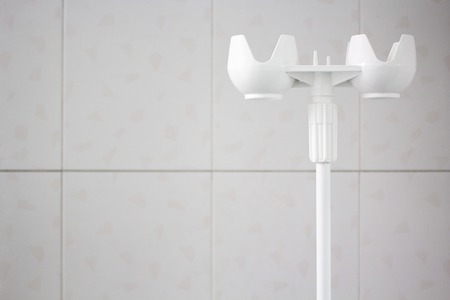 white the tripod to drip on a white tile backgroundの写真素材