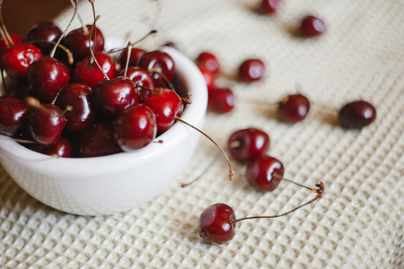 Fresh cherry on plate on towel background. fresh ripe cherries. sweet cherries.の写真素材