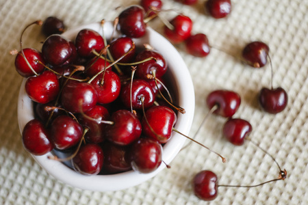 Fresh cherry on plate on towel background. fresh ripe cherries. sweet cherries.の写真素材