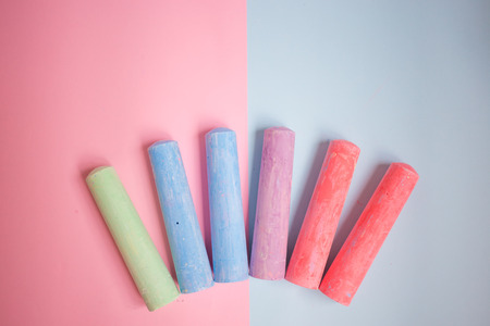 a set of multicolored crayons for children on the pastel background