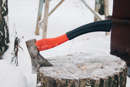 axe with handle stack in the chopped wood, winterの写真素材