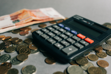 Russian money, coins and banknotes, calculator on the grey background, finance business conceptの写真素材