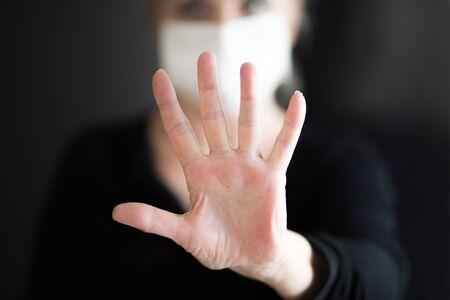Senior woman wearing mask, shows clean hands and show stop hands gesture for stop corona virus outbreak. Coronavirus and epidemic virus symptoms.の写真素材