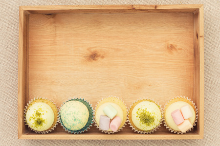 Five cupcakes in a wooden boxの写真素材