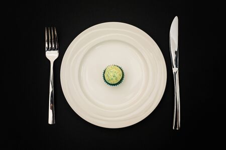 a small cupcake on a white plateの写真素材