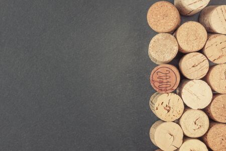 A collection of wine corks on a stone plateの写真素材