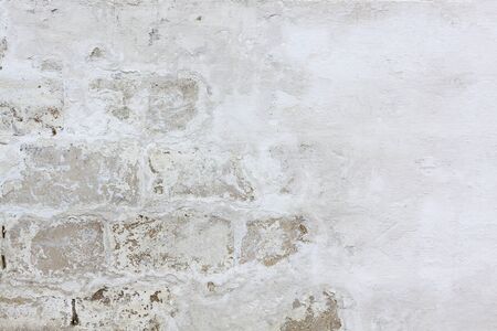 A texture of an old painted scratched brick wallの写真素材