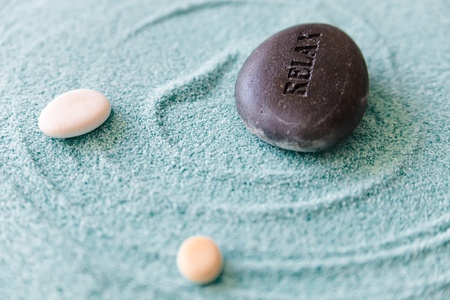 Stone with a sign Relax on a sand, zen stones, sand therapy, meditation 