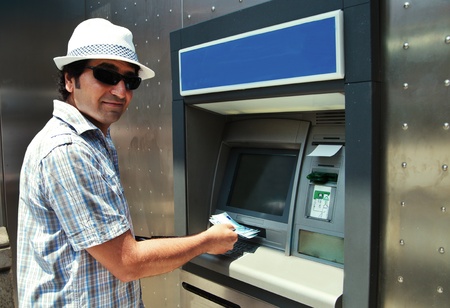 Tourist withdraws euro from ATMの写真素材